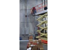 Commercial electrician in Mesa AZ warehouse installing conduit.